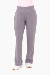 woman wearing gray fleece lounge pants with elastic waistband and side pockets