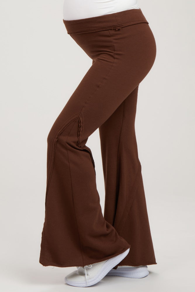 woman wearing brown maternity flared pants with a comfortable waistband and visible baby bump