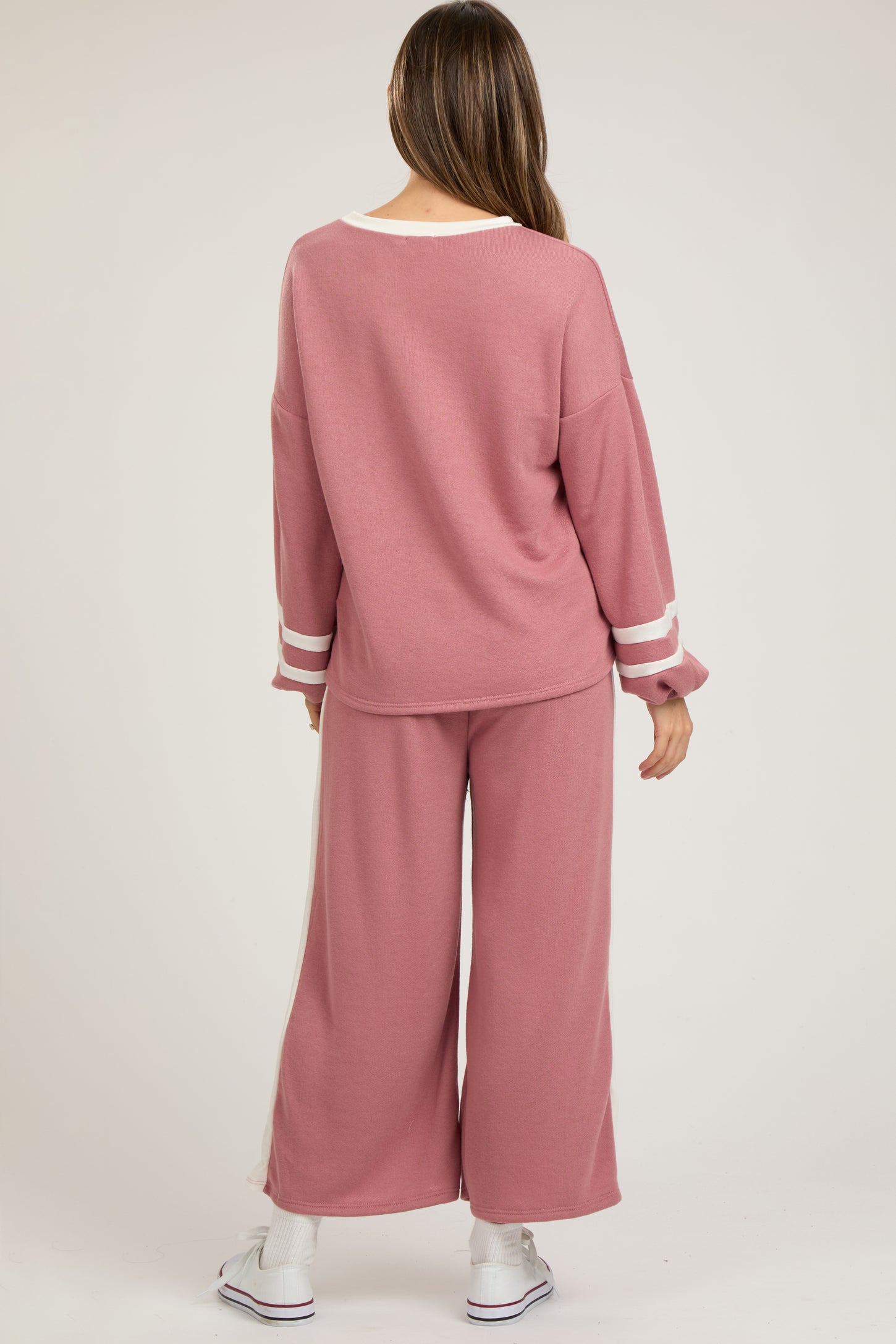woman wearing a pink maternity lounge set with wide-leg pants and long sleeve top, casual style from the back
