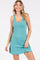 woman wearing a teal sleeveless dress with a scoop neckline and a relaxed fit