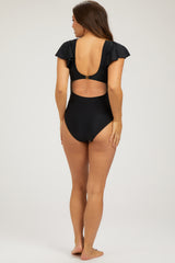 woman wearing a black maternity one-piece swimsuit with flutter sleeves and an open back