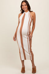woman wearing a white and tan striped maternity dress with a halter neck and a visible baby bump