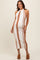 woman wearing a white and tan striped maternity dress with a halter neck and a visible baby bump