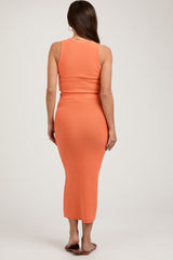 woman wearing a fitted orange maternity midi dress with a tank top and elastic waistband, viewed from the back
