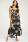 woman wearing a black floral print maternity maxi dress with ruffled straps and a visible baby bump