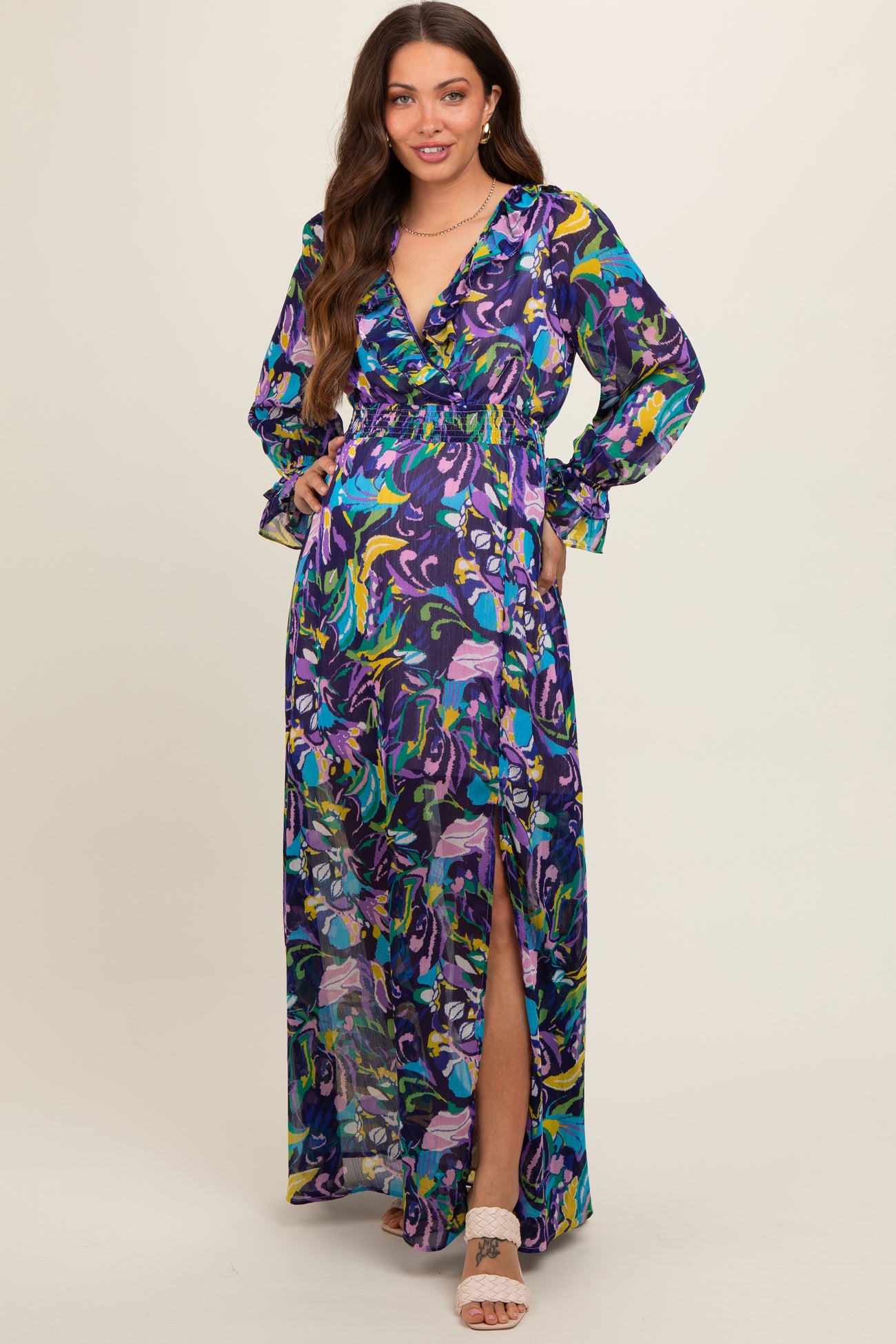 woman wearing a colorful floral print maternity maxi dress with a deep V-neck and side slit