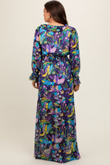 woman wearing a colorful floral print maternity maxi dress with long sleeves and a cinched waist, showing off her baby bump