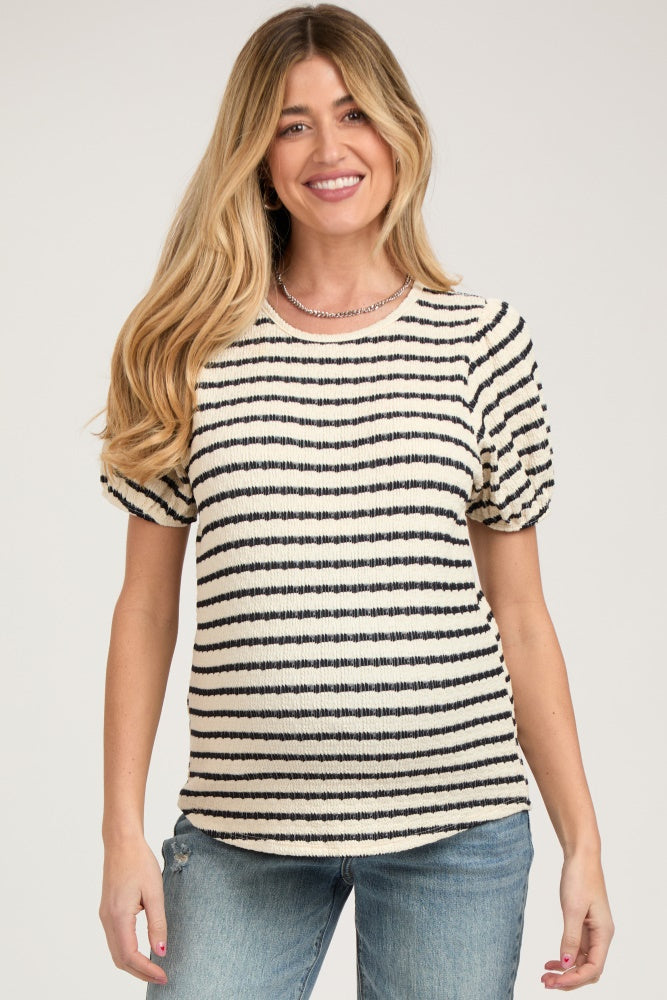 woman wearing a striped short sleeve maternity top with puff sleeves and a baby bump visible