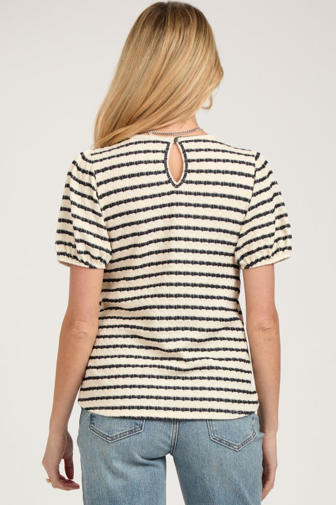 woman wearing a striped maternity top with short puff sleeves and a keyhole back detail