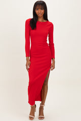 woman wearing a red ribbed long sleeve maxi dress with a side slit and strappy heels