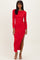 woman wearing a red ribbed long sleeve maxi dress with a side slit and strappy heels