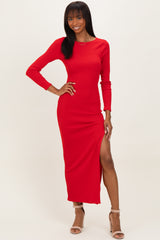 woman wearing a red ribbed long sleeve maxi dress with a thigh-high slit and strappy heels