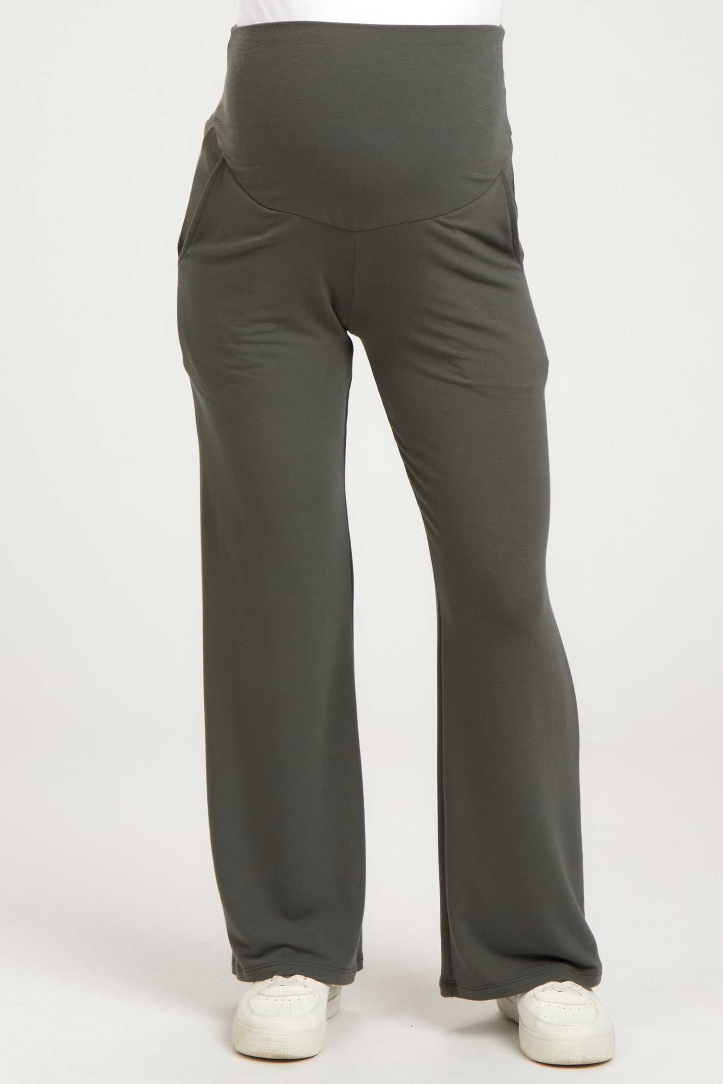 woman wearing gray maternity pants with a supportive waistband and side pockets