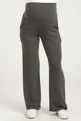 woman wearing gray maternity pants with a supportive waistband and side pockets