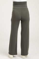 woman wearing olive green maternity pants with a high waistband and wide leg style, viewed from the back