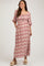 woman wearing a floral print maternity maxi dress with a square neckline and puff sleeves, showcasing her baby bump