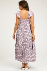 woman wearing a lavender floral maternity maxi dress with a smocked back and cap sleeves