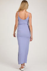 woman wearing a lavender ribbed maternity maxi dress with a form-fitting silhouette and a side slit