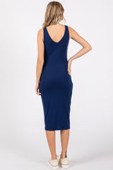 woman wearing a navy blue ribbed midi dress with a scoop back and fitted silhouette