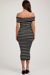 woman wearing a black and white striped off-the-shoulder maternity dress, fitted style, showing her back
