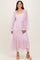 woman wearing a light pink tiered tulle dress with long sleeves and a smocked bodice
