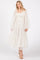 woman wearing a white tiered maxi dress with sheer puff sleeves and a smocked bodice