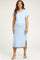 woman wearing a light blue ribbed maternity dress with short sleeves and side slits, showing her baby bump