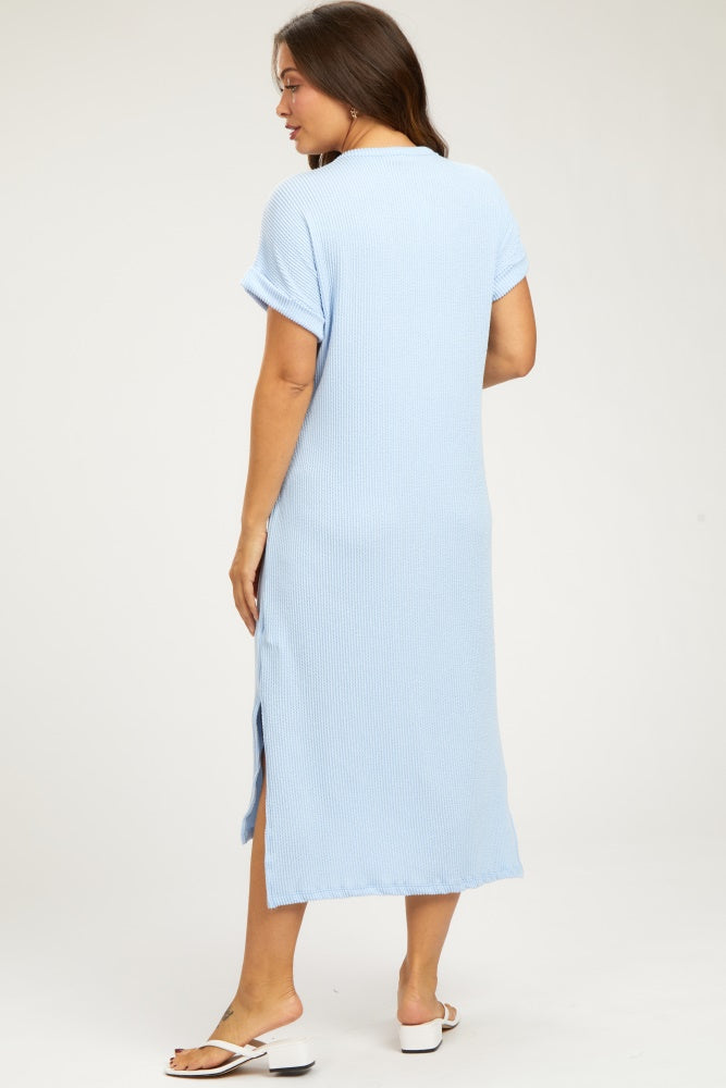 woman wearing a light blue maternity dress with short sleeves and side slits, shown from the back