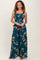 woman wearing a teal floral maxi dress with smocked bodice and adjustable straps