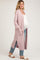 woman wearing a light pink maternity cardigan over a white tank top, with a visible baby bump, paired with light blue jeans