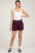 woman wearing a white tank top and purple maternity shorts with an elastic waistband