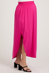 maternity wear in bright pink maxi skirt with side slits, featuring an elastic waistband and styled with black strappy sandals