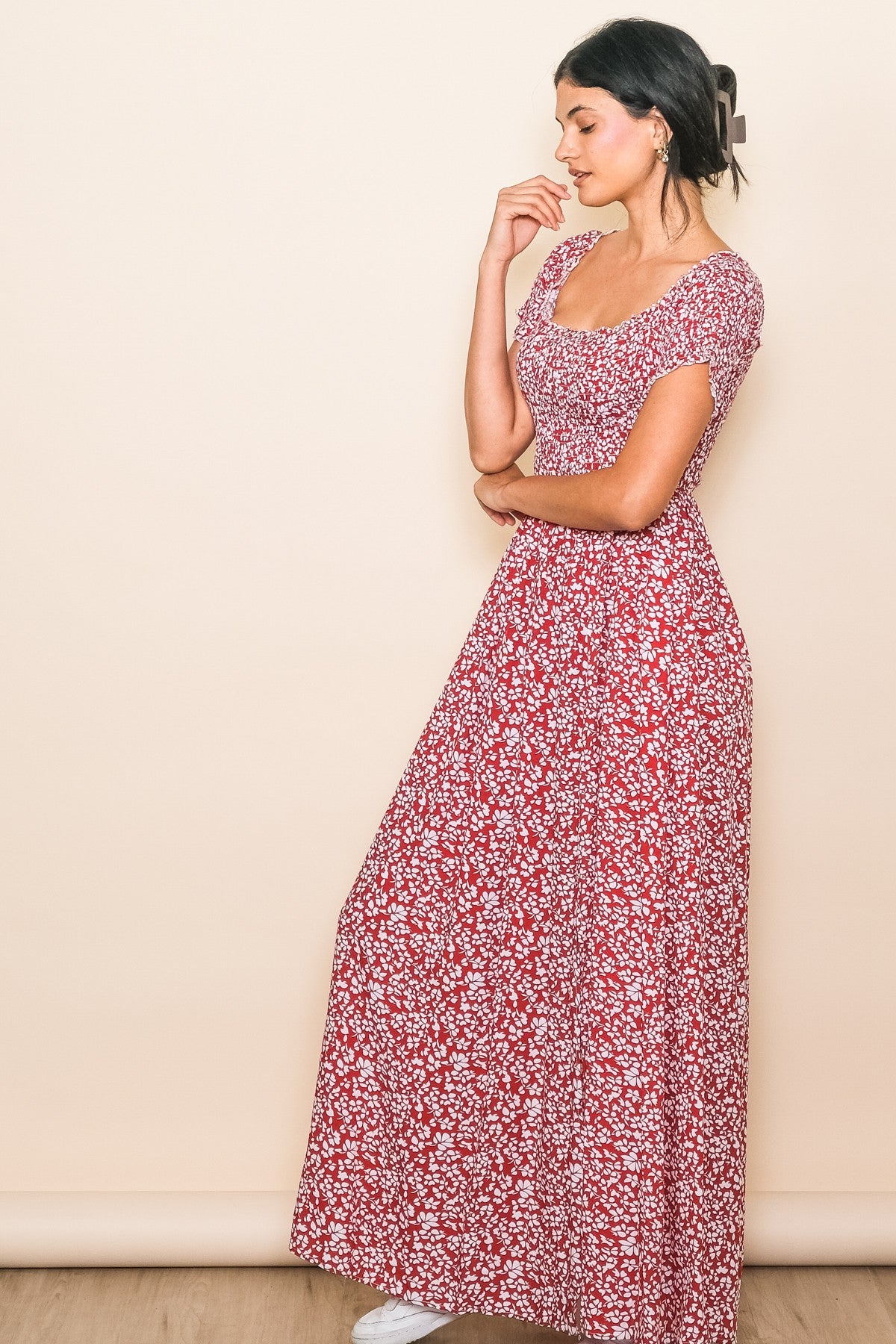 woman wearing a red floral maxi dress with a square neckline and short sleeves