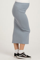 maternity wear light blue ribbed midi skirt on a model with a visible baby bump, paired with black sneakers and white socks