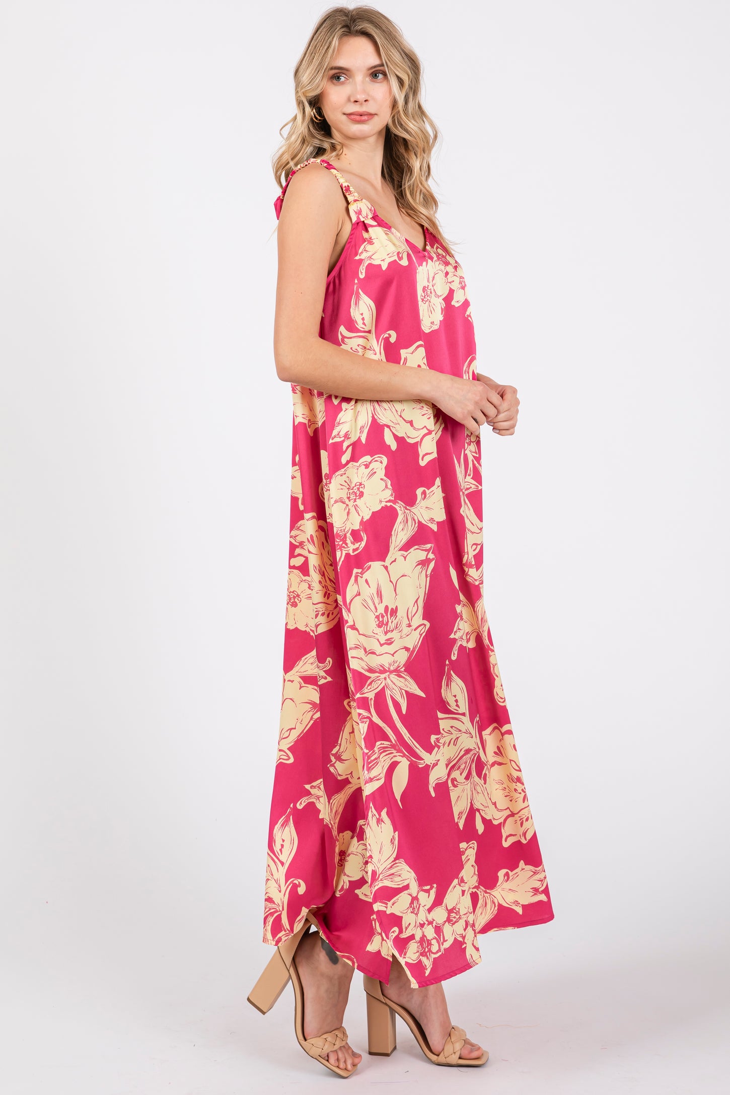 woman wearing a pink floral maxi dress with a V-neck and flowy silhouette