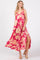 woman wearing a pink floral maxi dress with a side slit and adjustable straps