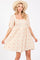 woman wearing a beige puff sleeve floral print dress with a square neckline and buttons down the front