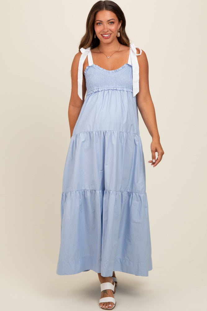 woman wearing a light blue maternity maxi dress with smocked bodice and tie straps