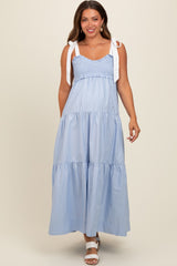 woman wearing a light blue maternity maxi dress with smocked bodice and tie straps