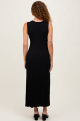 woman wearing a black sleeveless maxi dress with a ribbed texture, showing the back view