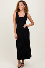 woman wearing a black sleeveless ribbed maxi dress with a fitted bodice and flowing skirt