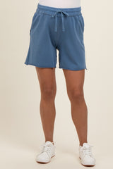 woman wearing blue maternity shorts with an elastic waistband and side pockets