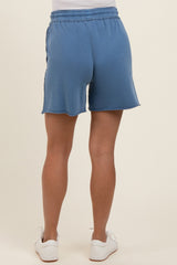 woman wearing blue maternity shorts with a comfortable elastic waistband, shown from the back