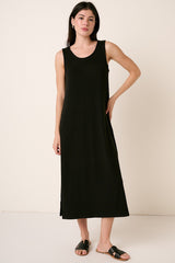 woman wearing a black sleeveless maxi dress with side slits and a relaxed fit