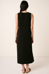 woman wearing a black sleeveless maxi dress, shown from the back