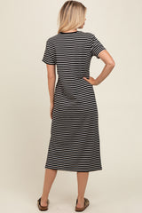 woman wearing a black and white striped short sleeve maxi dress, standing with her back to the camera