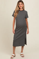woman wearing a black and white striped maternity dress with a knee-length hem and short sleeves, showing her baby bump