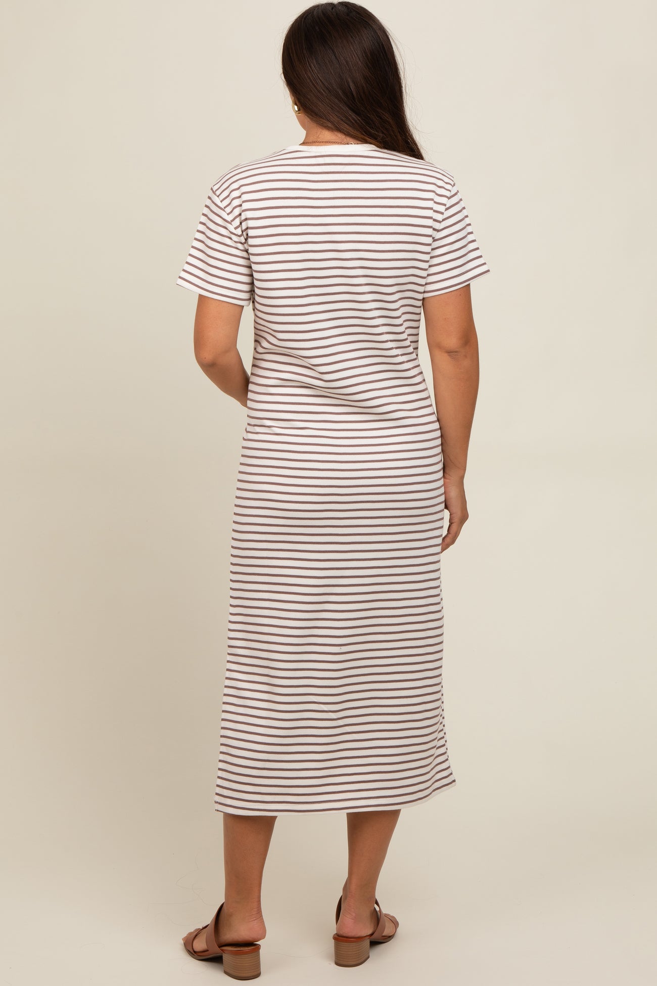 woman wearing a striped maternity maxi dress with short sleeves and a relaxed fit, showing a baby bump
