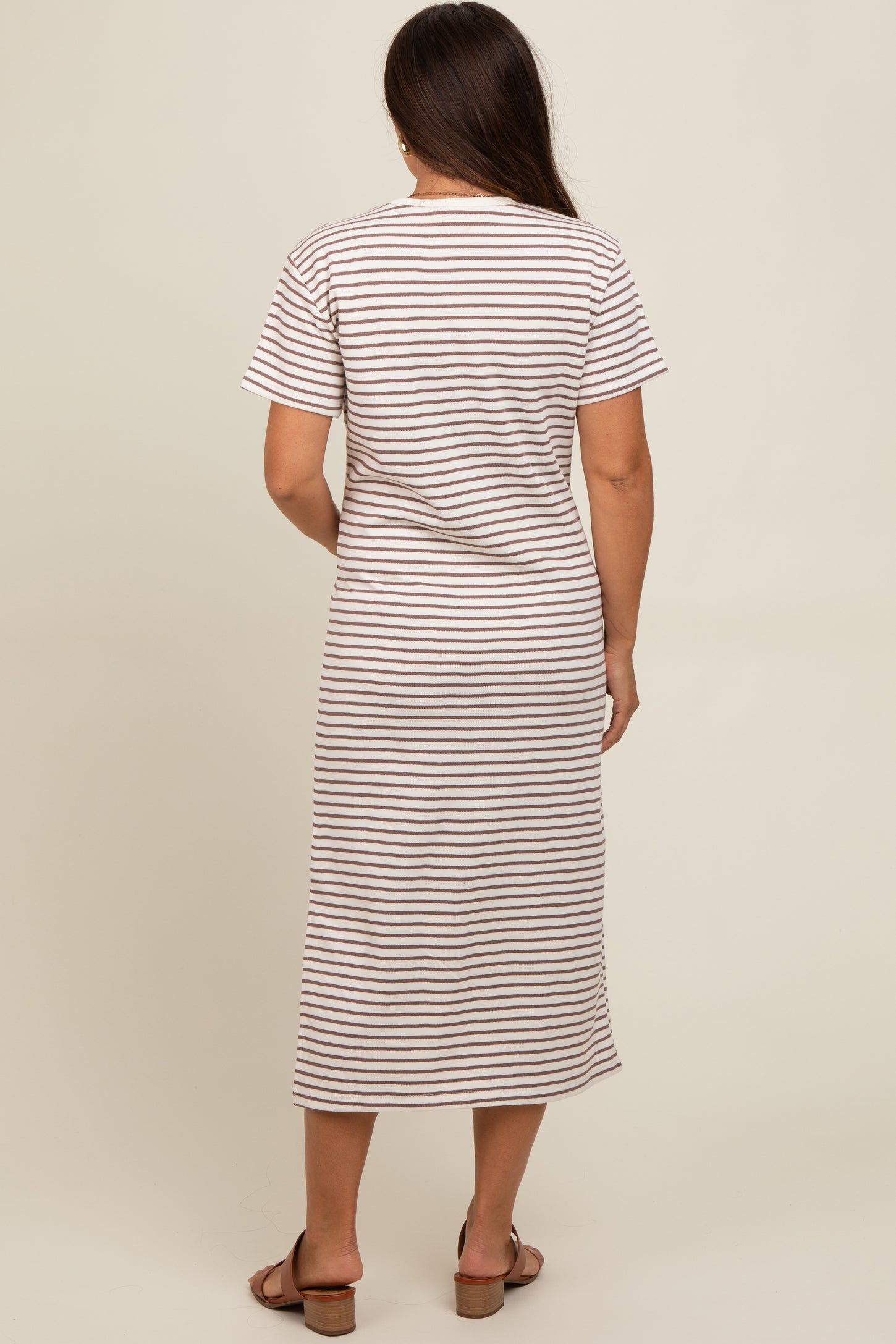 woman wearing a striped maternity maxi dress with short sleeves and a relaxed fit, showing a baby bump
