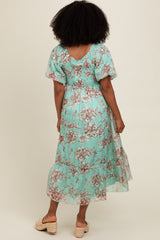 woman wearing a floral mint green midi dress with short sleeves and a smocked bodice, seen from the back